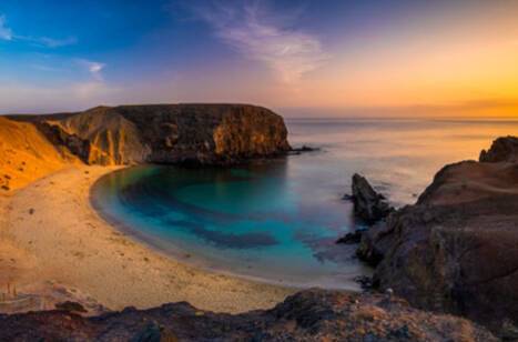 Panoramic image of Lanzarote beach at sunset