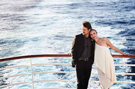 A couple standing on a cruise ship deck