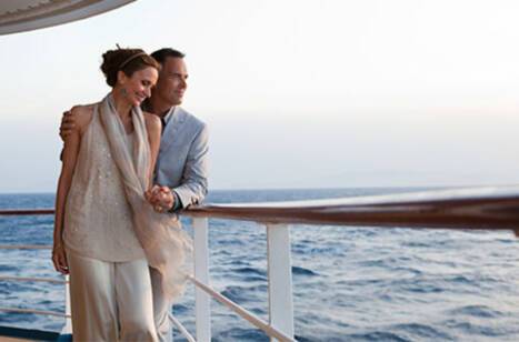 A couple standing on the deck of Seven Seas Explorer