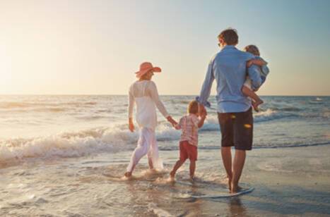 A family walking along the beach in the Mediterranean