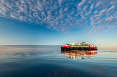 A cruise ship at sea during sunrise