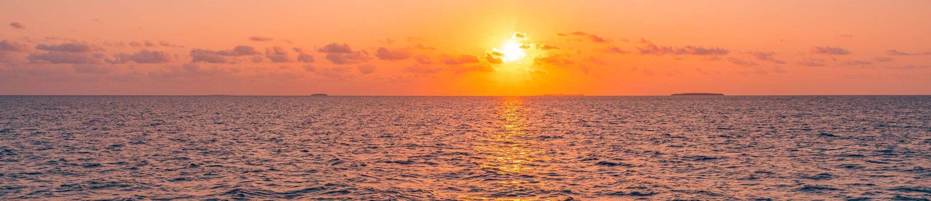 Panoramic image of the sun setting over the horizon