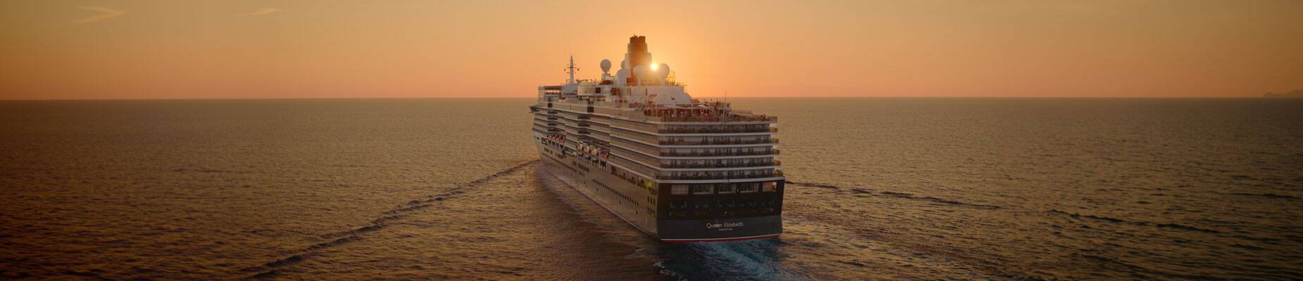 Queen Elizabeth sailing towards the sunset