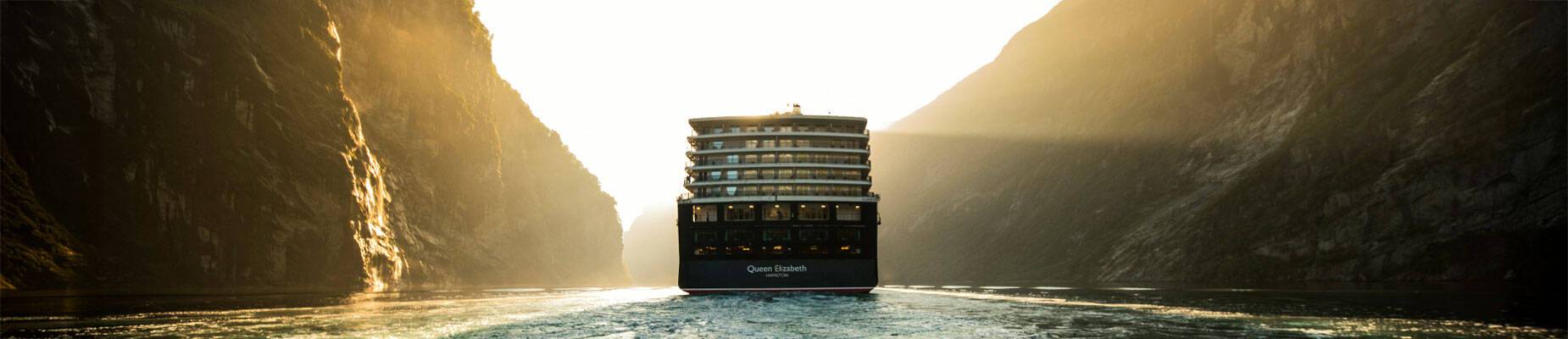 Queen Elizabeth sailing through a Norwegian fjord