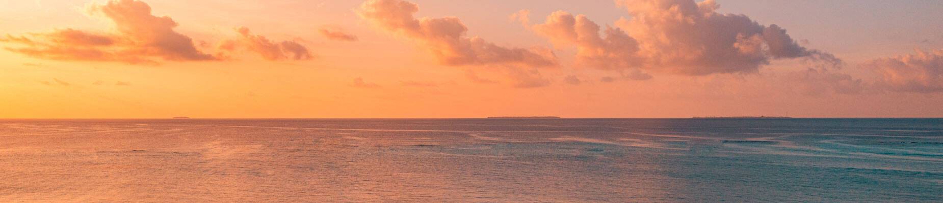 A panoramic image of the horizon and sunset at sea