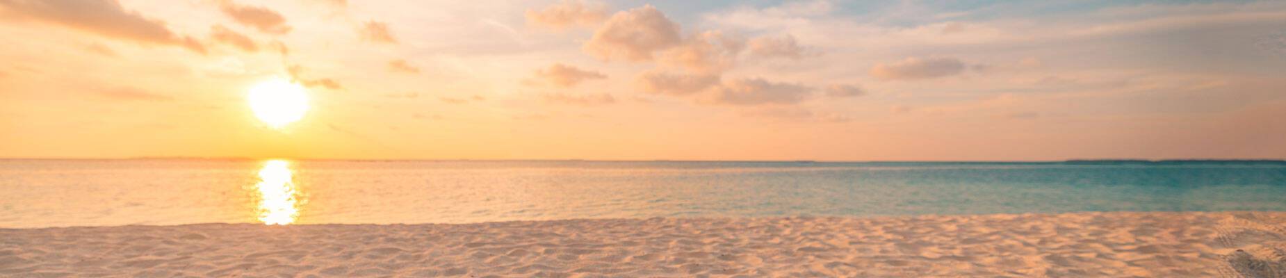 Panoramic image of the sun setting over the horizon