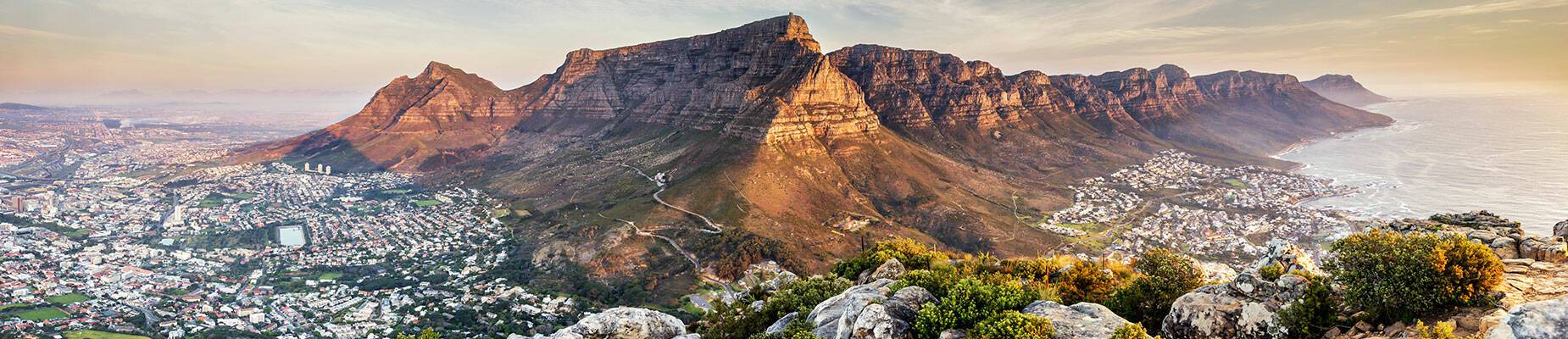 A panoramic view of the sun setting over Cape Town