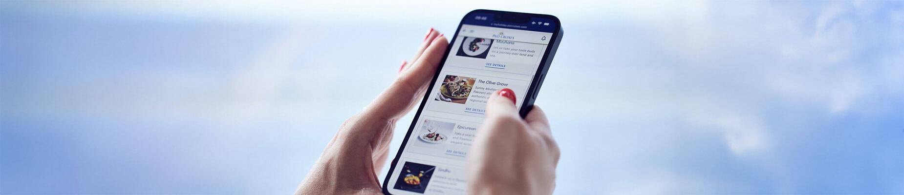 A person holding a phone with the My Holiday app on it