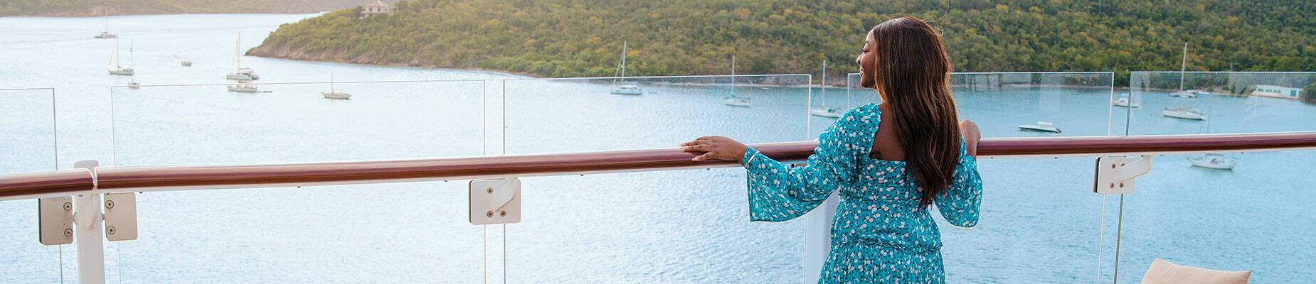 A person standing on the deck of a cruise ship