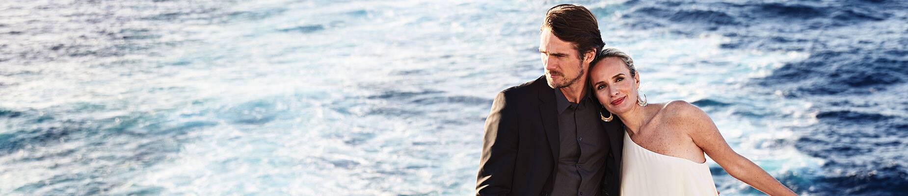 A couple standing on a cruise ship deck