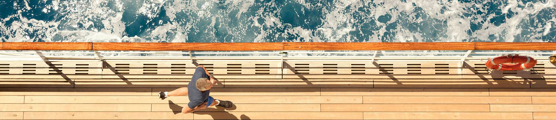 A guest running on deck of a Cunard ship