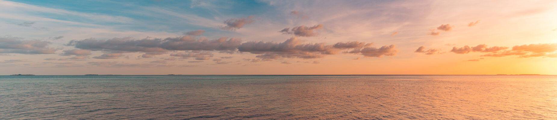 Panoramic image of the sun setting over the horizon