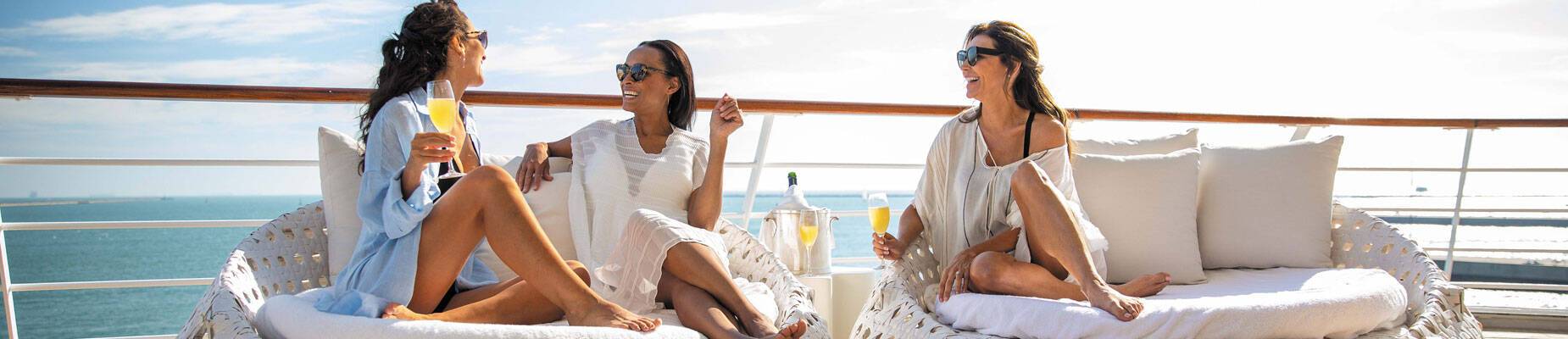 Three women chatting on board a Regent Seven Seas cruise ship