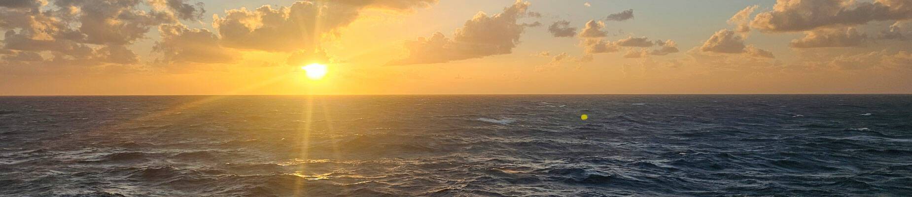 The sun setting on the horizon