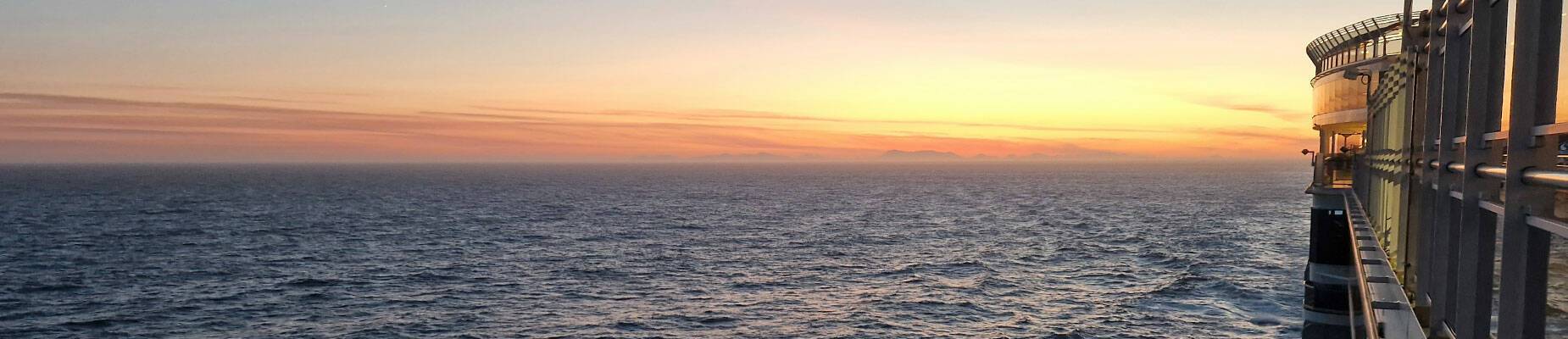 Queen Elizabeth at sea at sunset