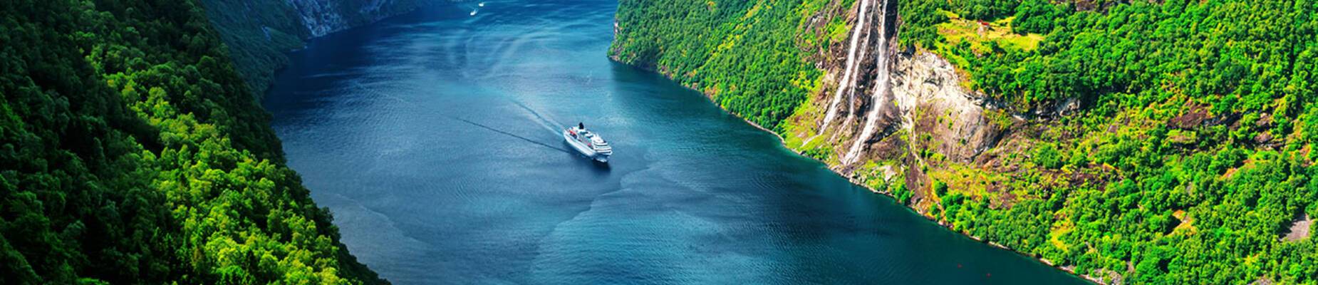 A cruise ship sailing through a Norwegian Fjord