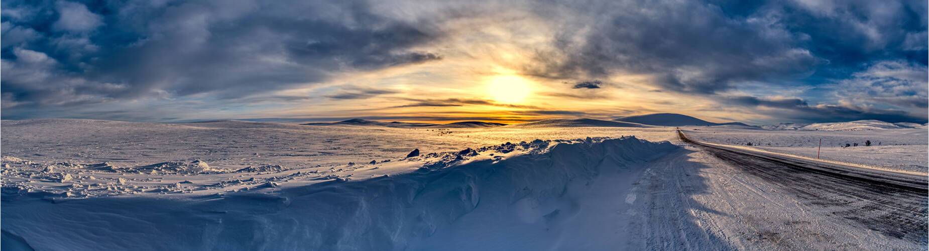 A snowy road into Alta at sundown